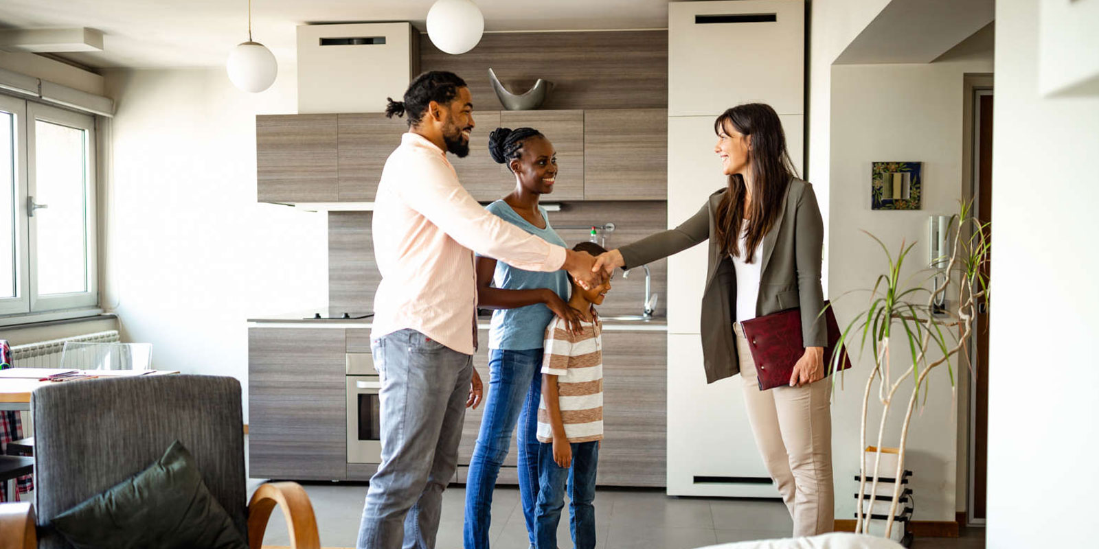 Real estate agent shaking hands with a family